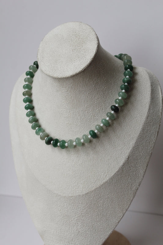 Green beaded Sea Glass Necklace displayed on a jewelry bust.