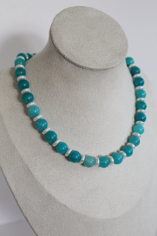 Handcrafted aqua beaded necklace with pearl accents displayed on a jewelry bust.