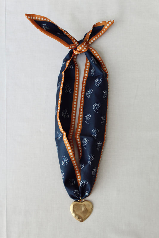 Autumn Navy scarf necklace with navy paisley print burnt orange trim and gold heart pendant